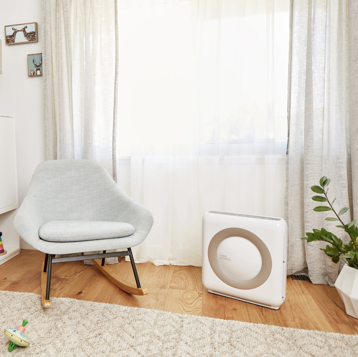 coway air purifier next to chair