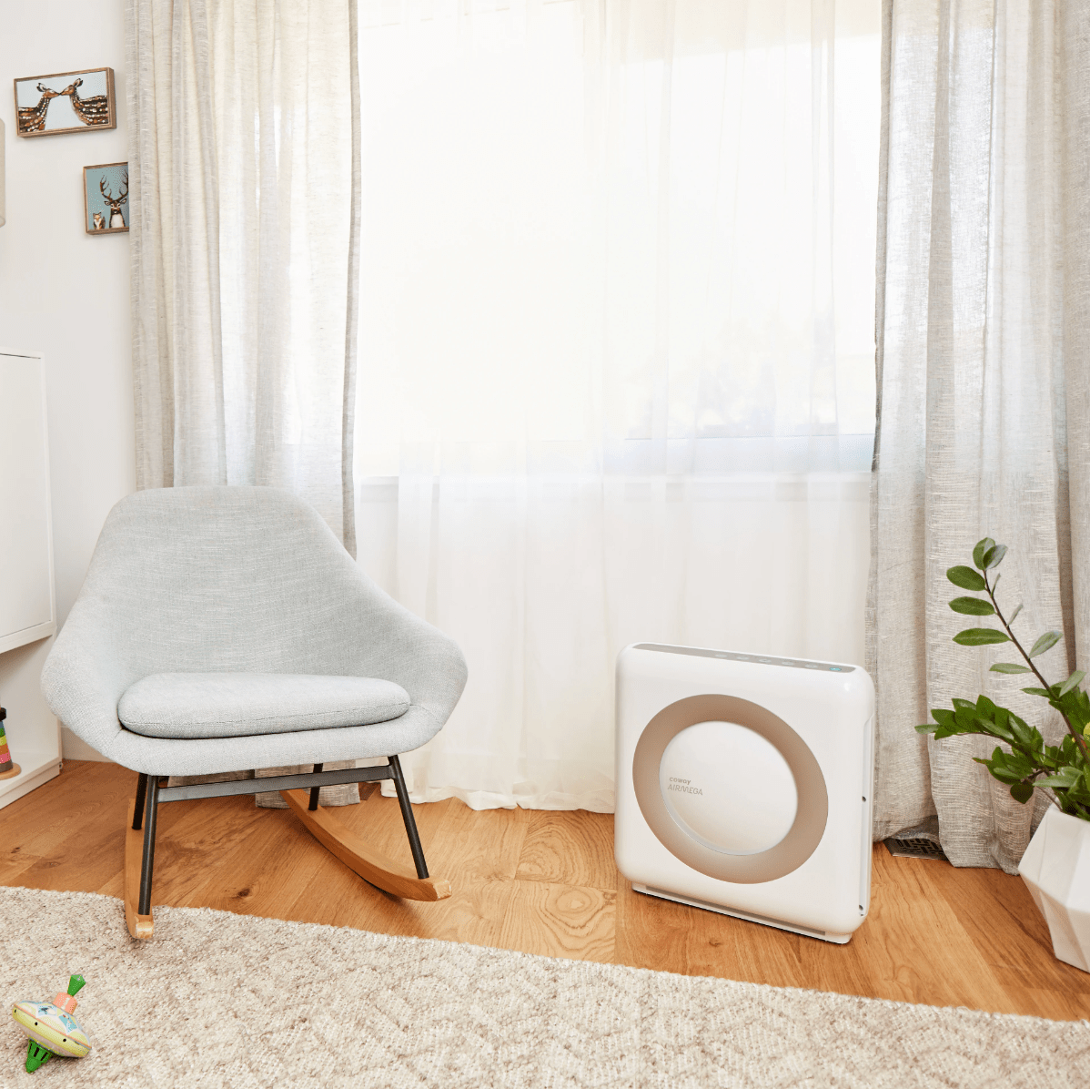coway air purifier next to chair