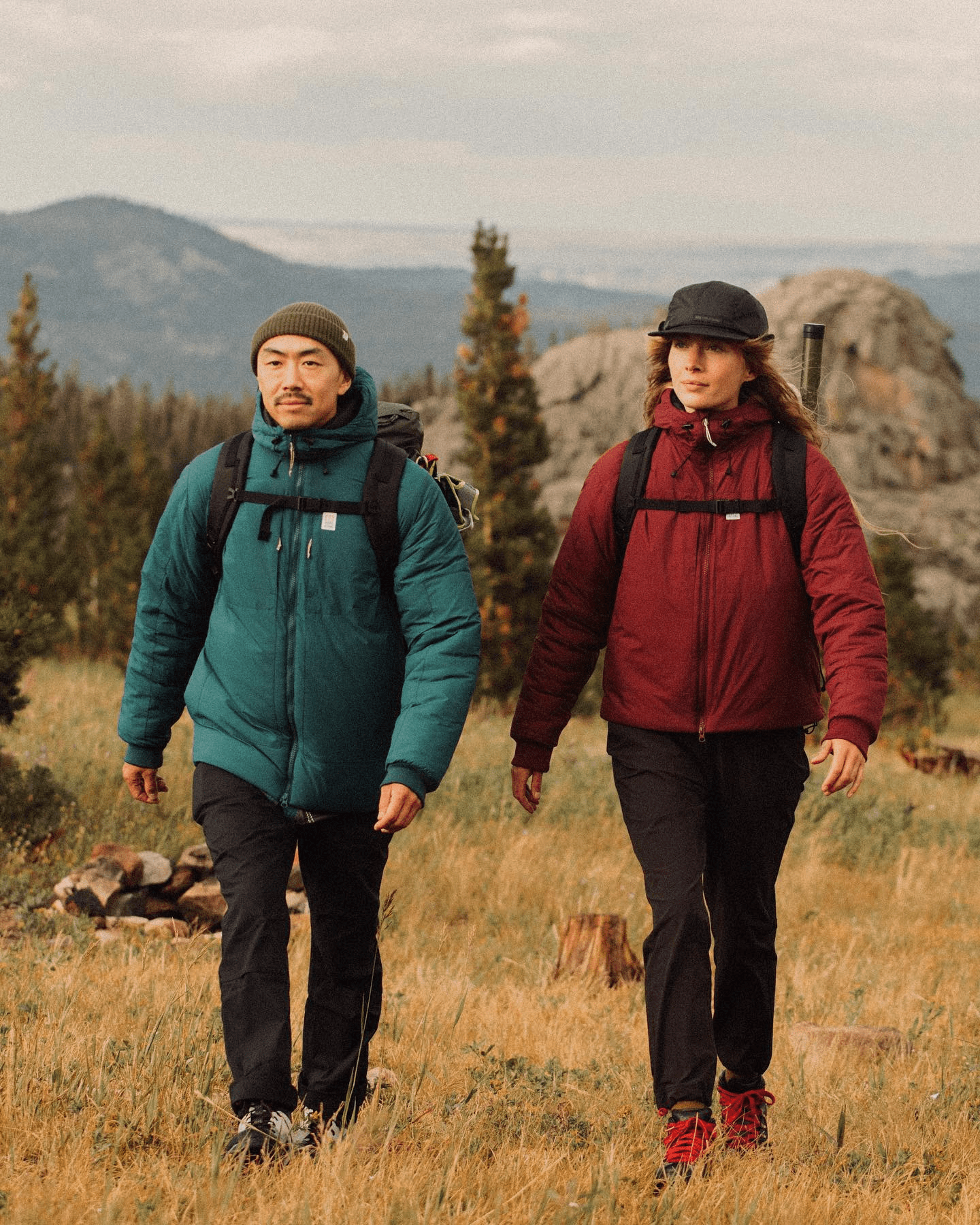 guy and gal walking in the mountains