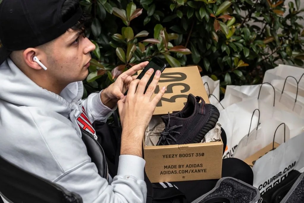 a young man shows off his new yeezy boost model designed by