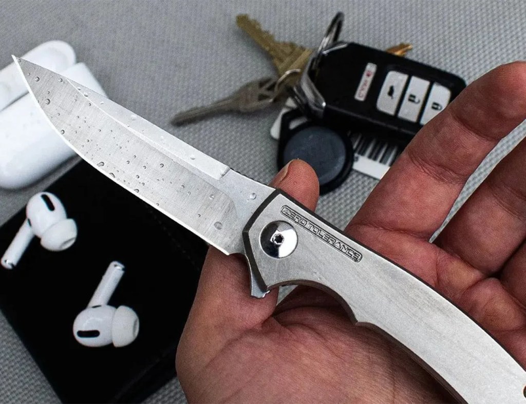 a person holding a zero tolerance knife