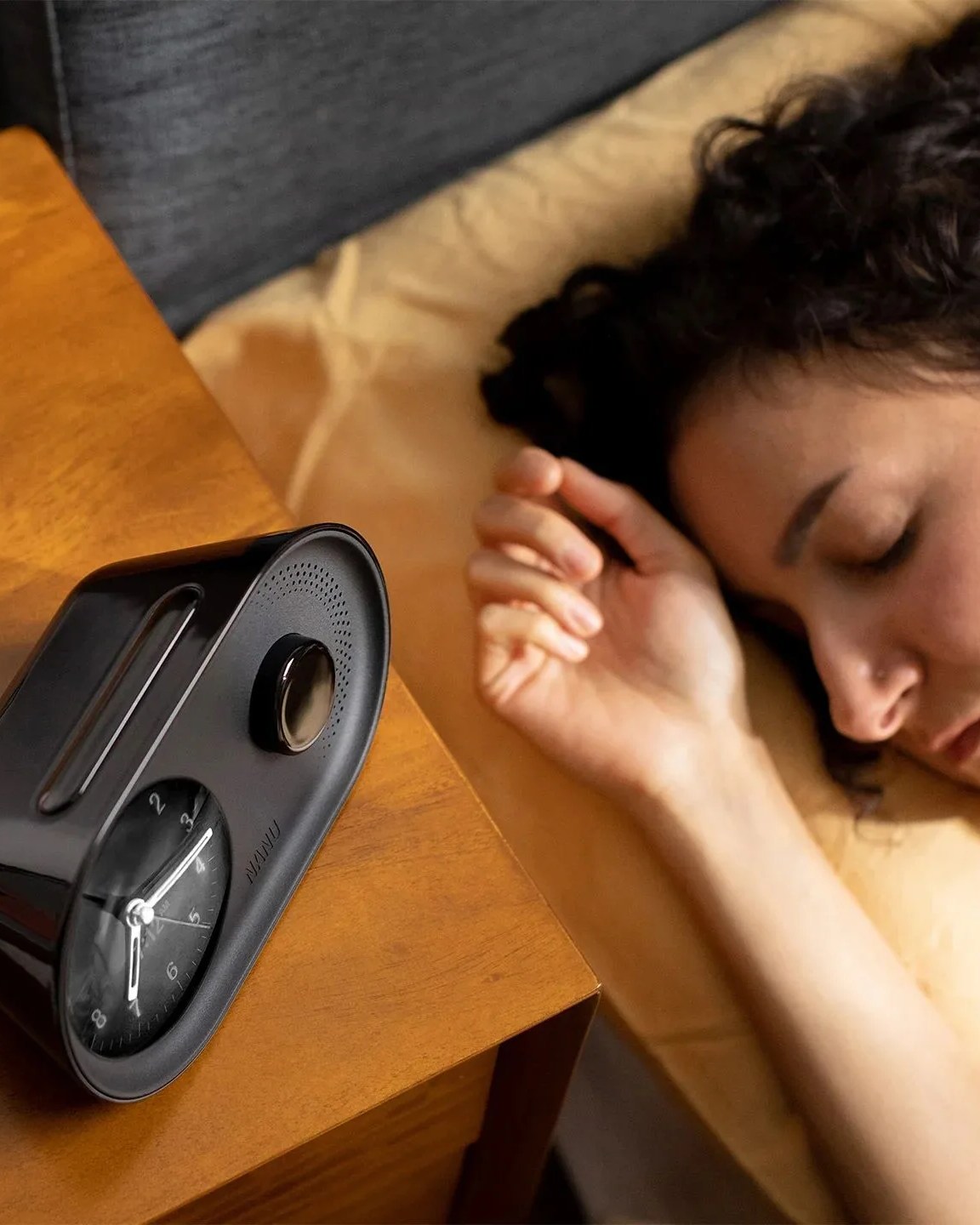woman sleeping next to nanu arc alarm clock