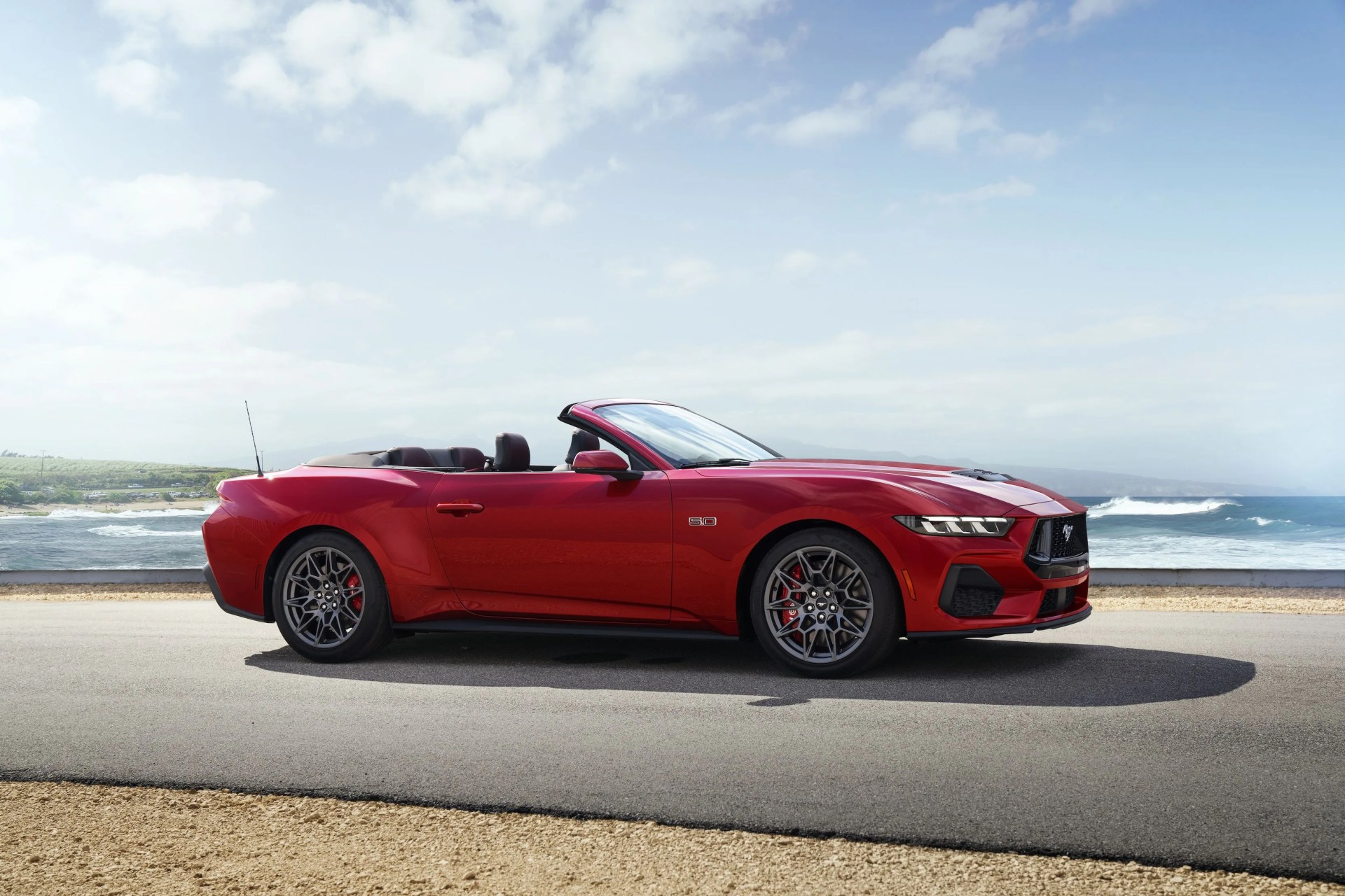 2024 ford mustang convertible parked by the ocean