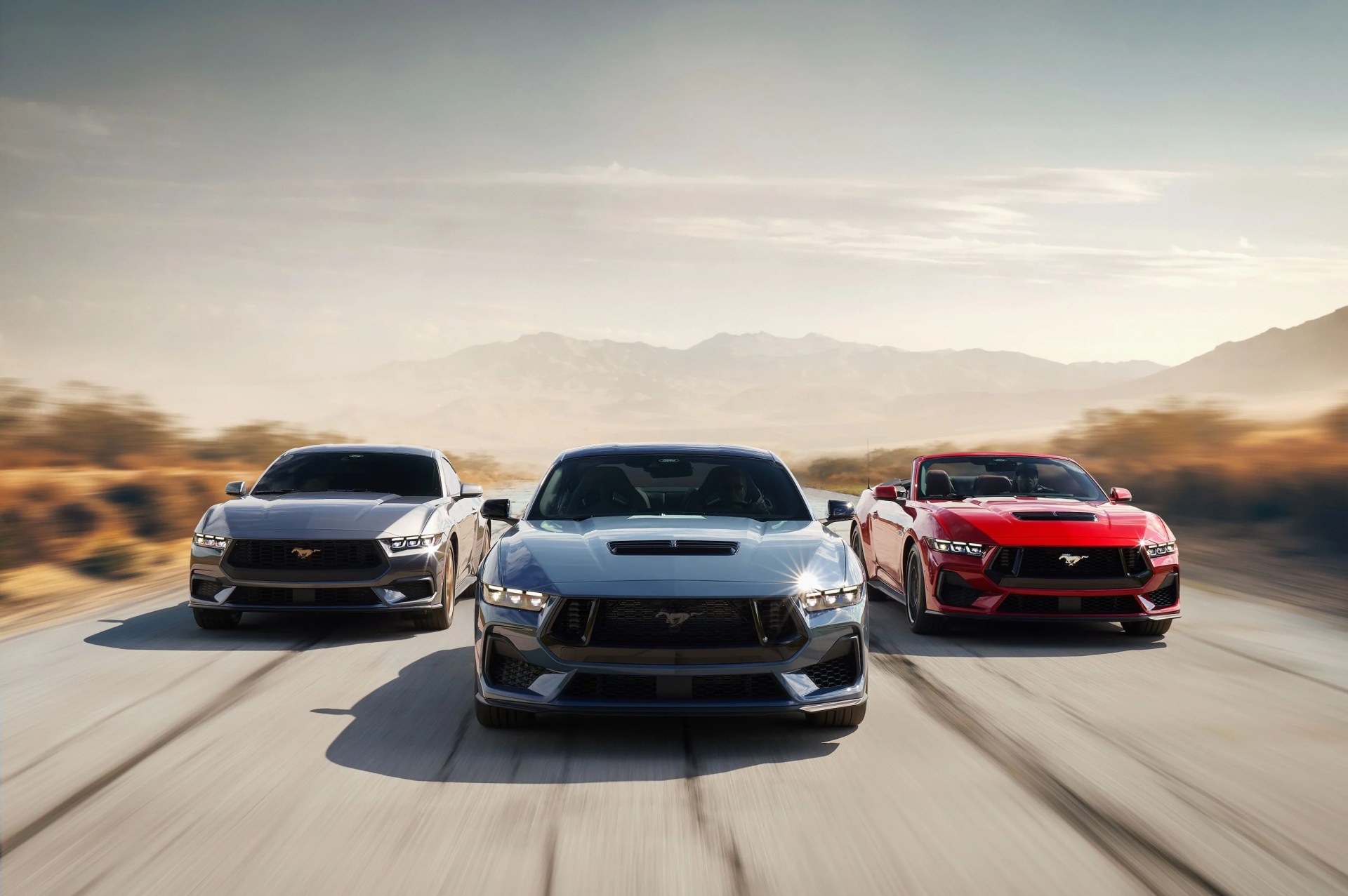 2024 ford mustangs parked three abreast on a road