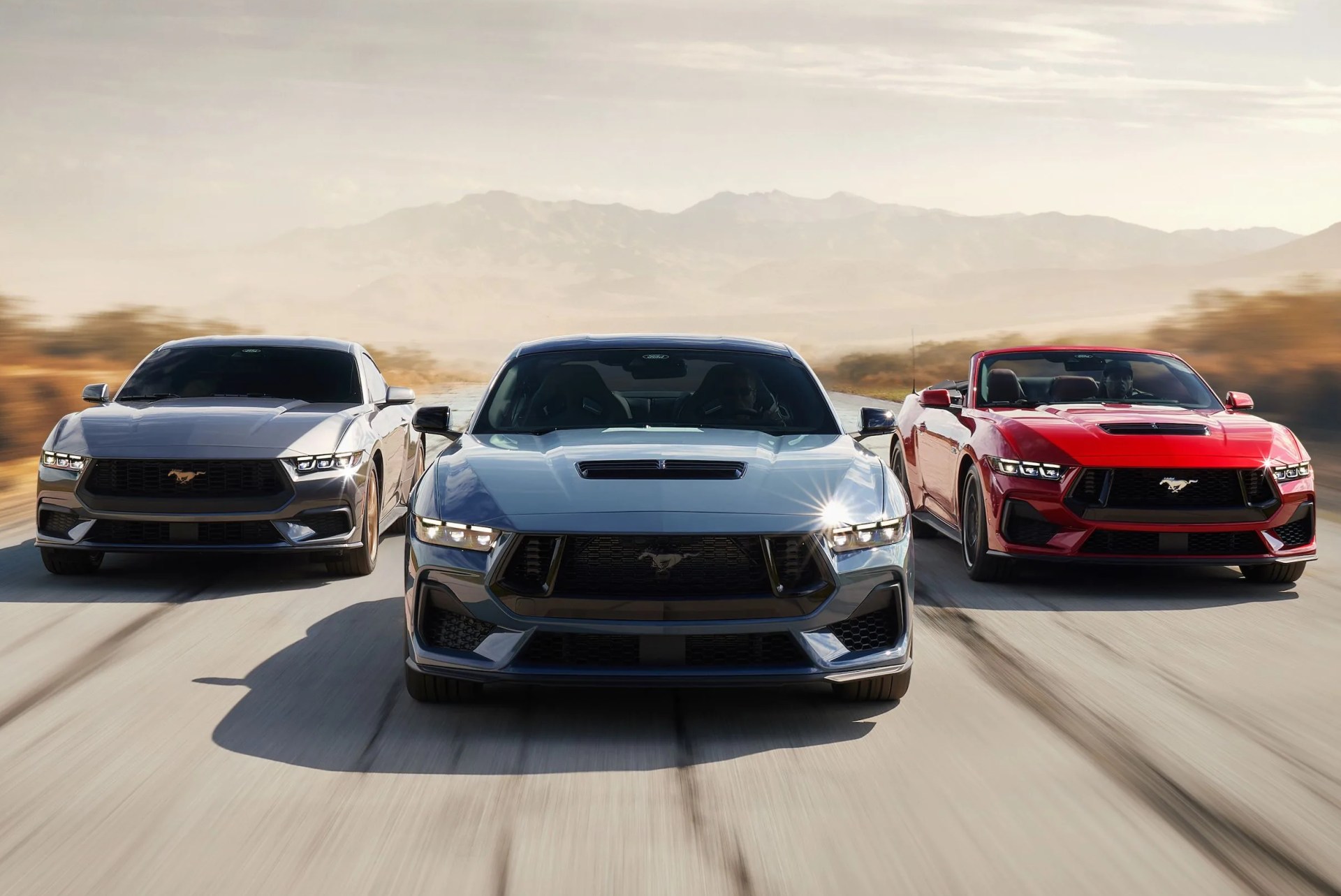 2024 ford mustangs parked three abreast on a road