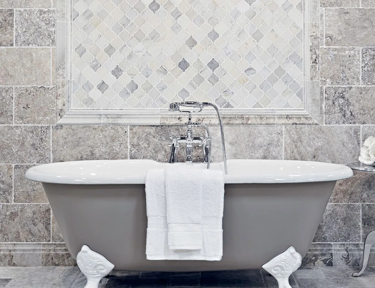 a tiled bathroom with a clawfoot tub