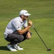 adidas man leaning on golf stick wearing heat ready jogger pants