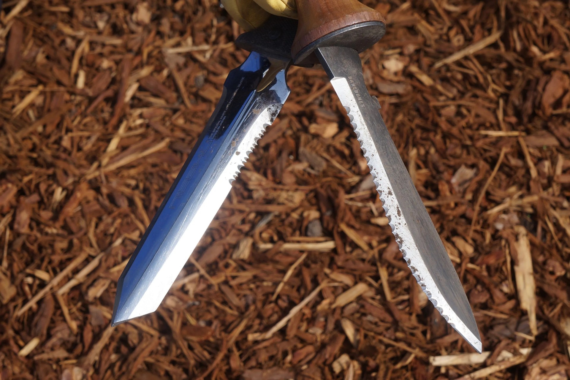 two gardening knives with mulch in the background
