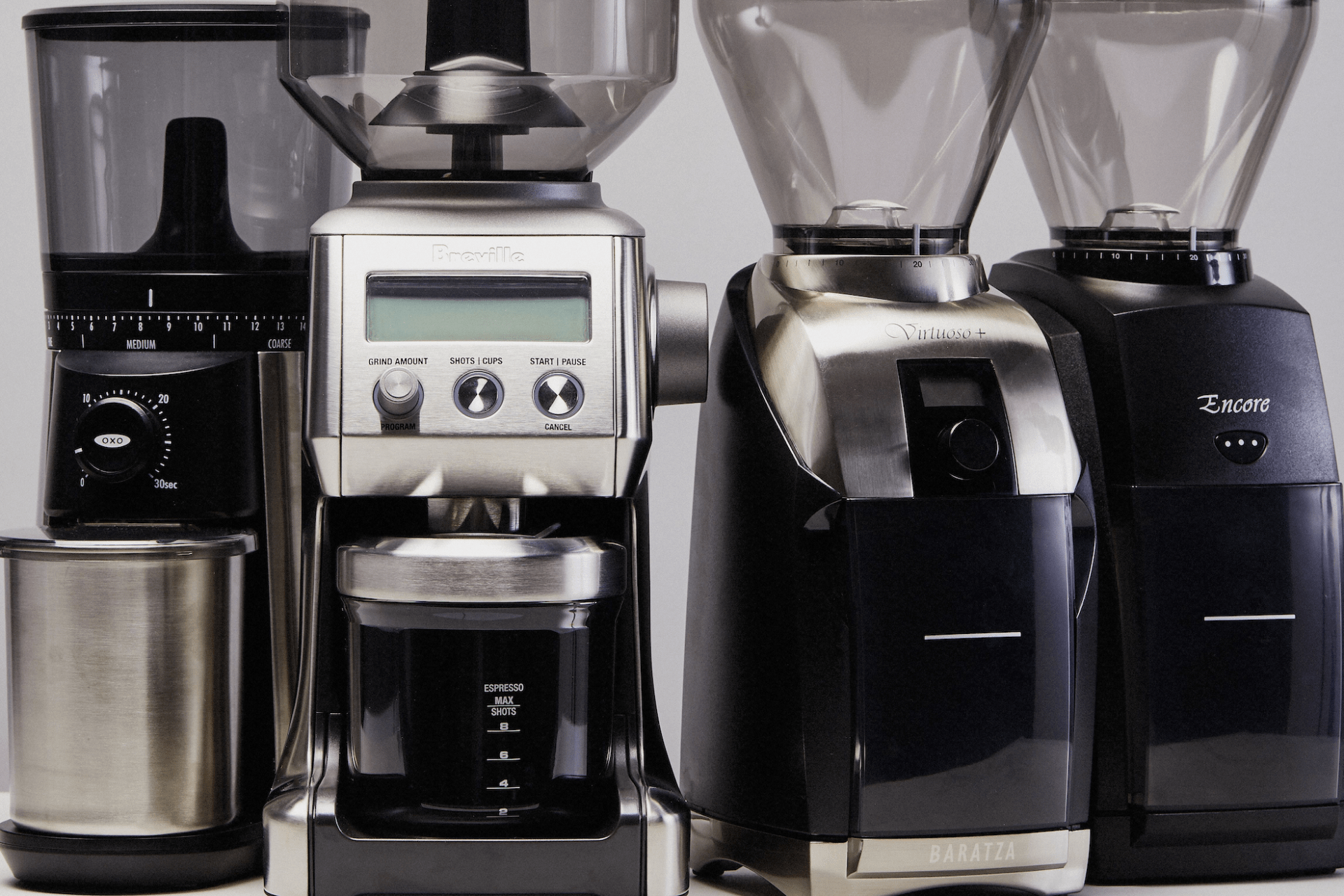 four coffee grinders side by side