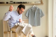 man sewing a shirt