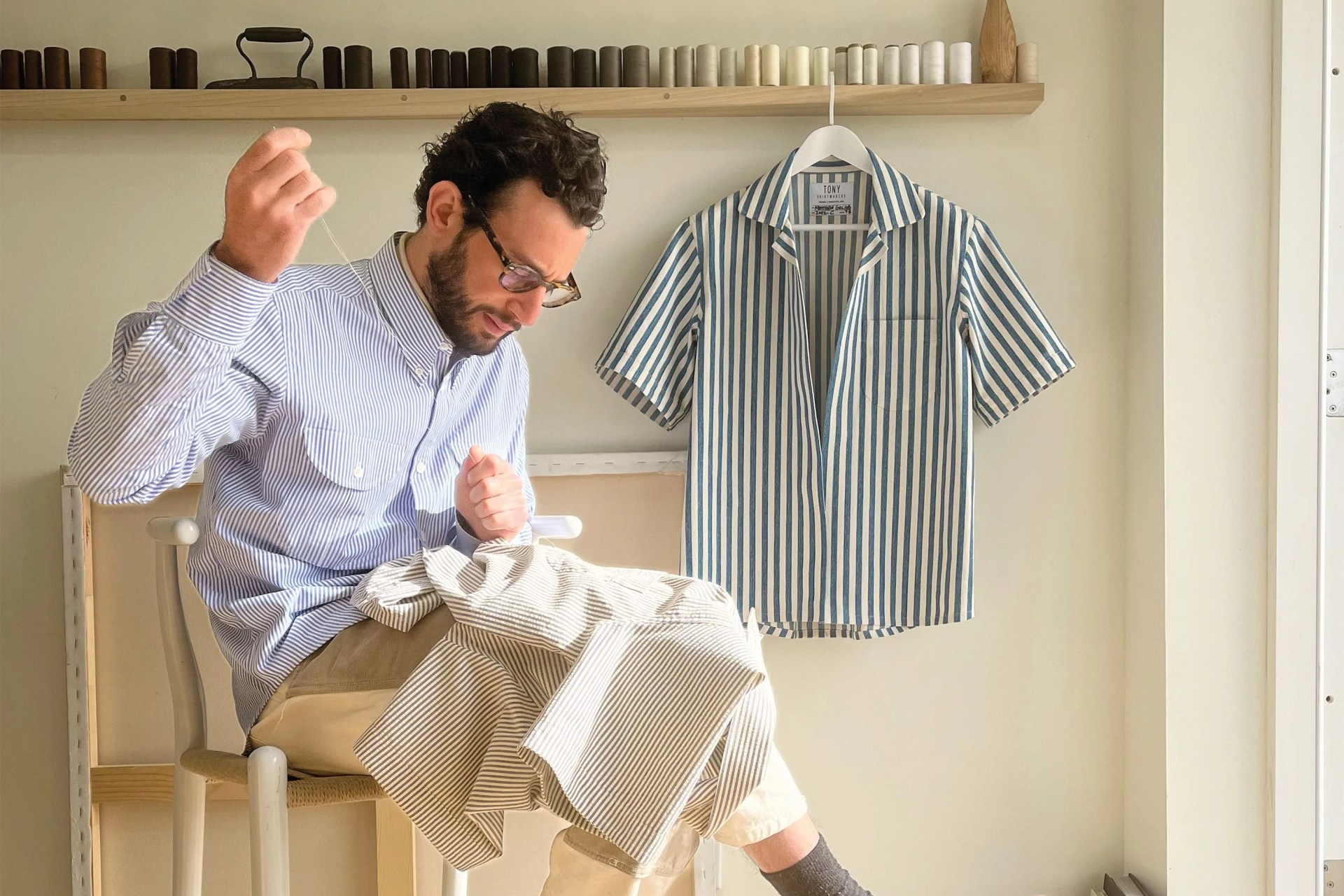 man sewing a shirt