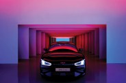 front of a kia car with headlights on