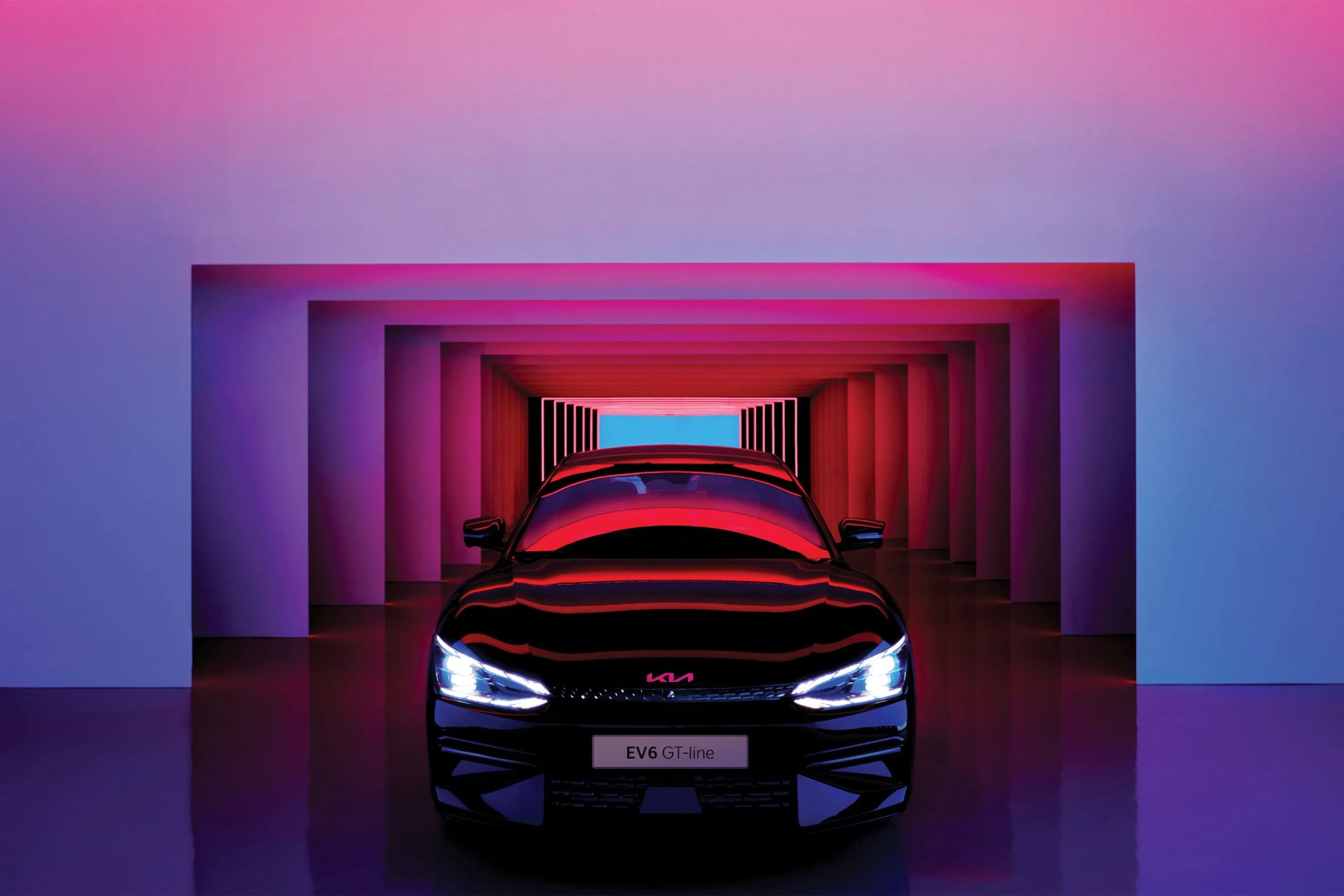 front of a kia car with headlights on