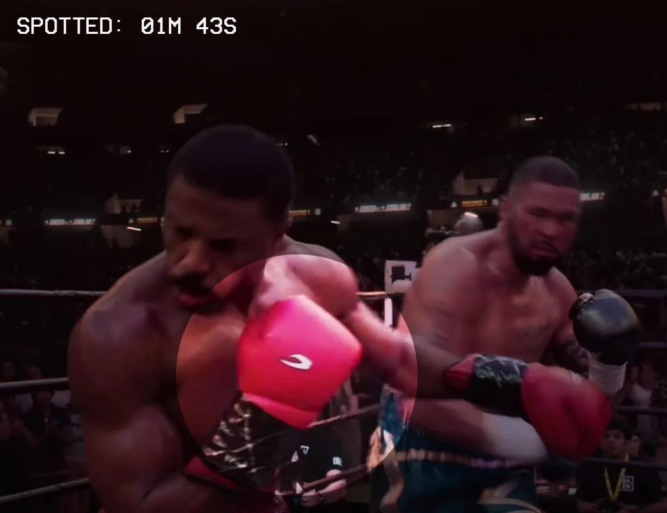 two boxers fighting with red and black boxing gloves on
