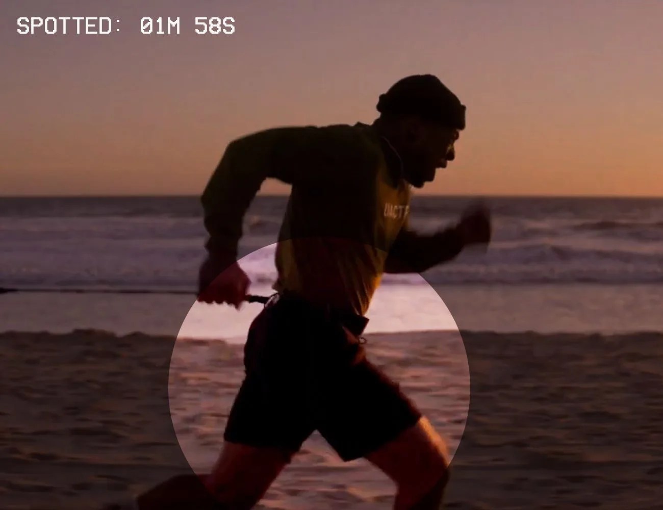 a man running on the beach with black nike shorts on