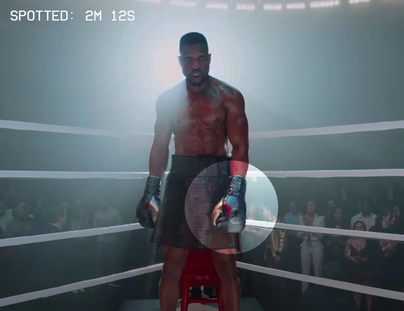 a boxer standing in the corner of the ring with black and gold gloves on