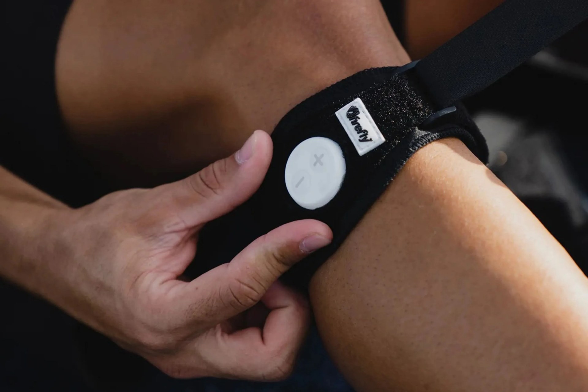 a firefly portable recovery device on a persons leg