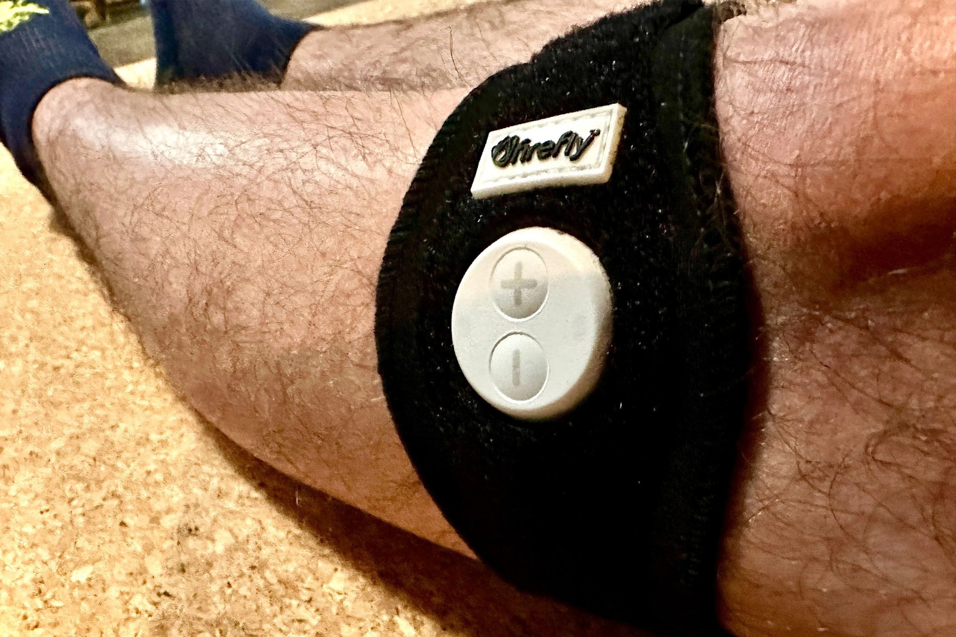 a firefly portable recovery device on a man's leg