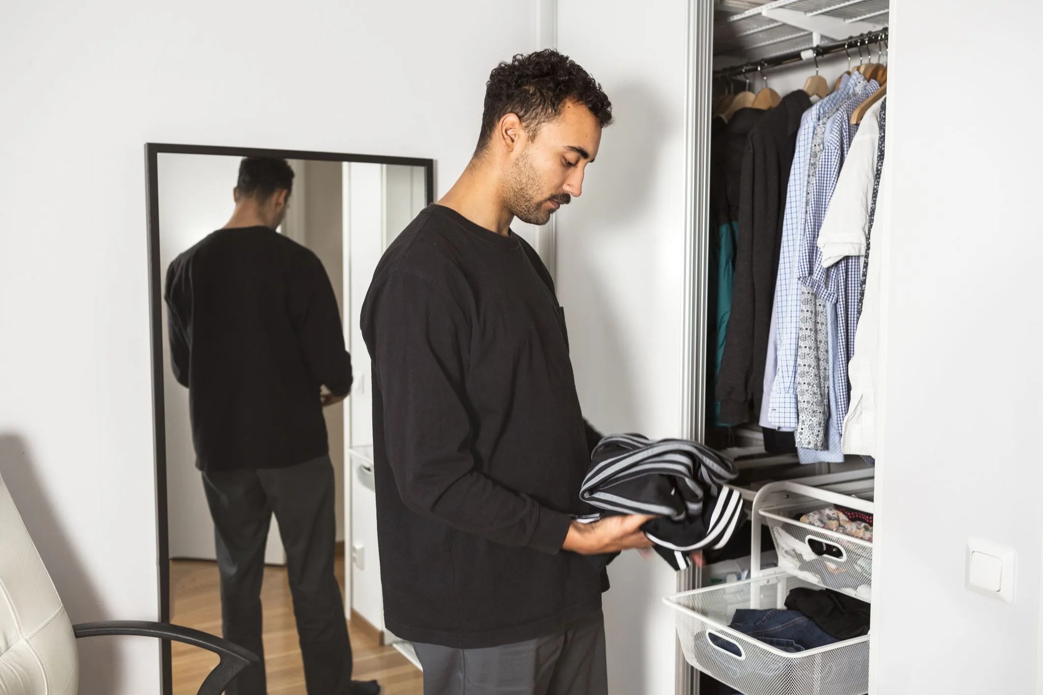 man folding clothes