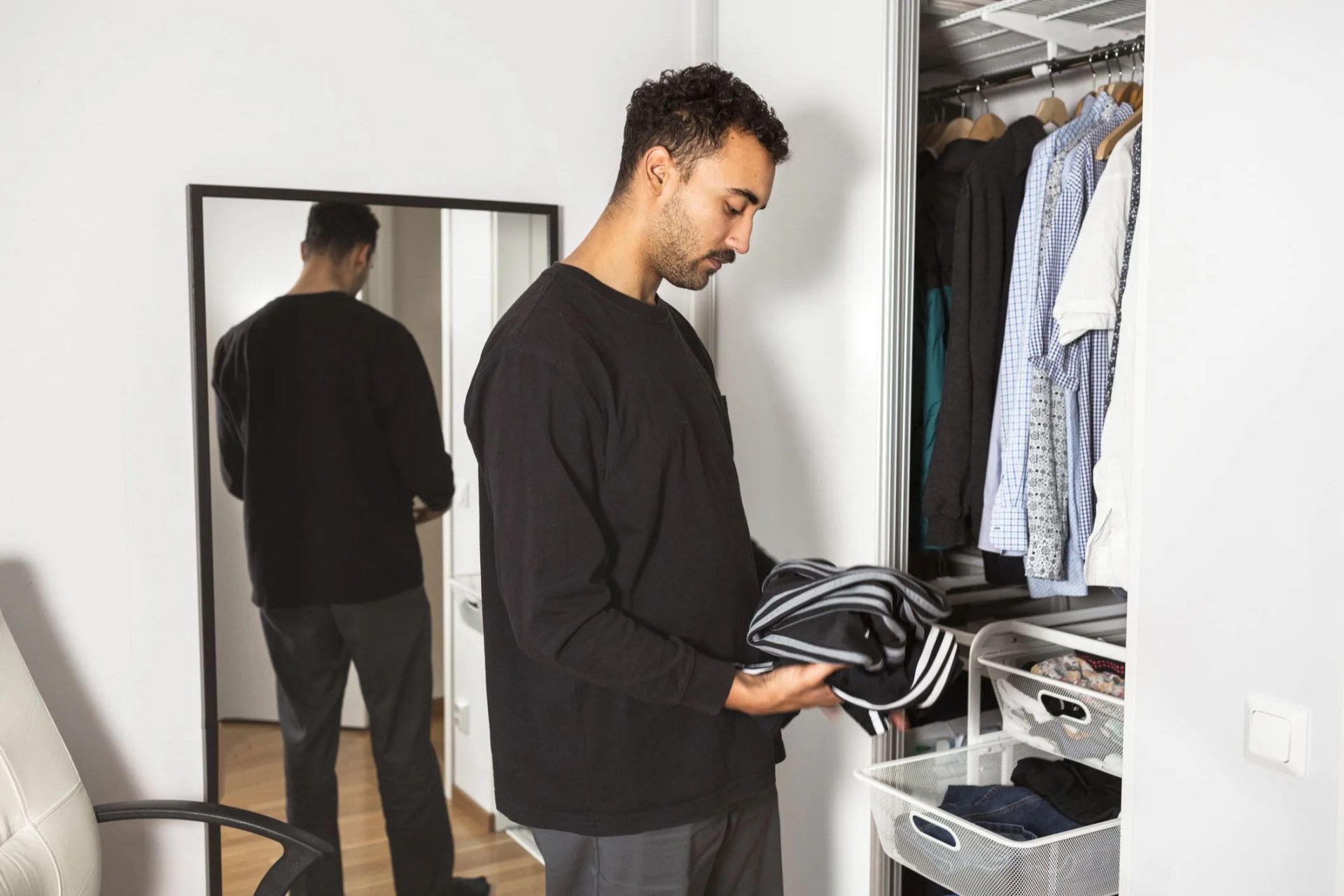 man folding clothes
