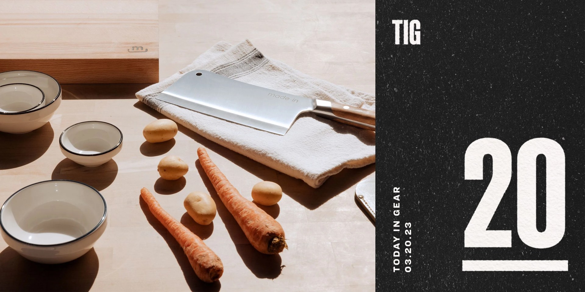 a butcher knife on a table with a cloth napkin, bowls, cutting board, potatoes, and carrots