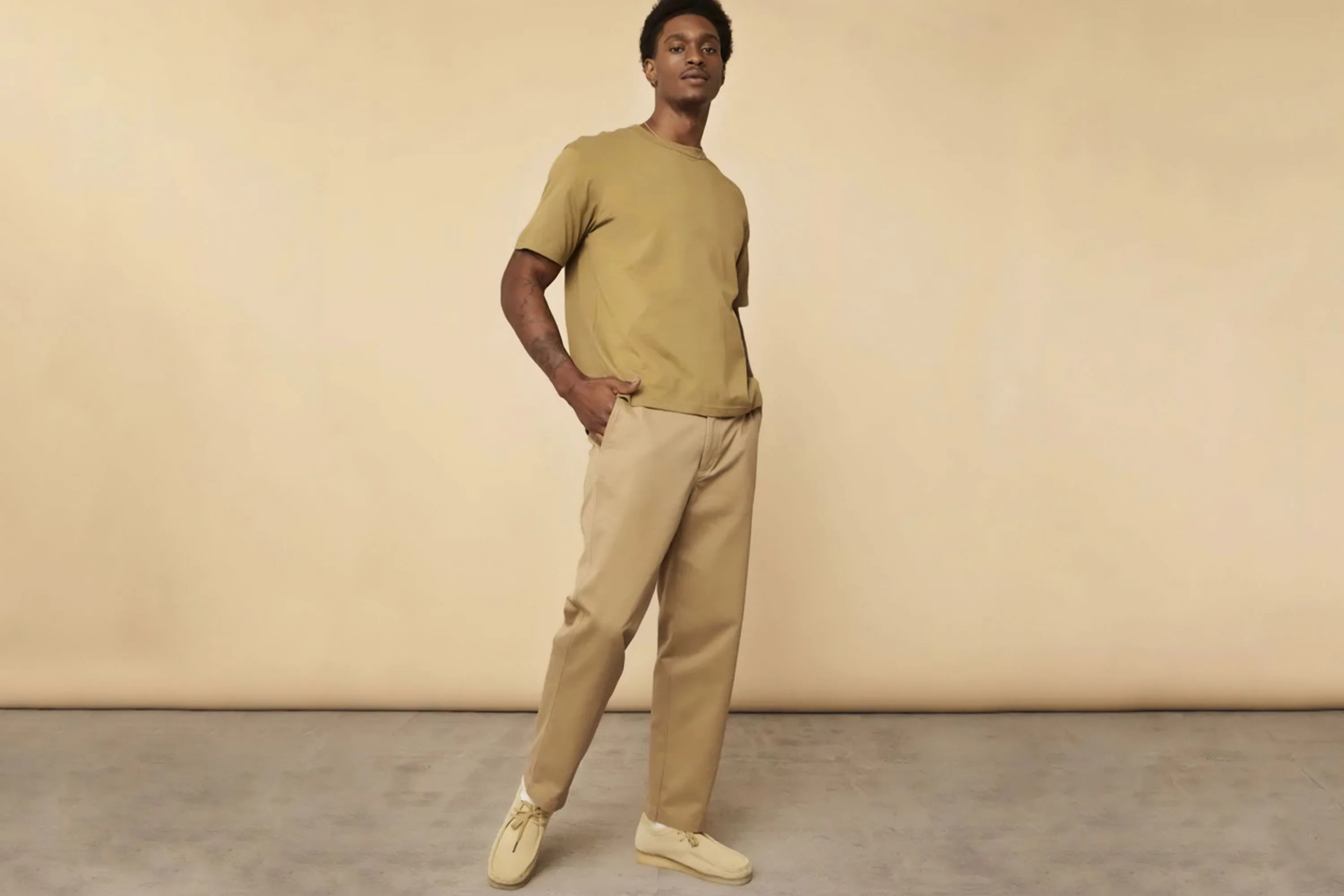 a man wearing khaki chinos and a tan tshirt