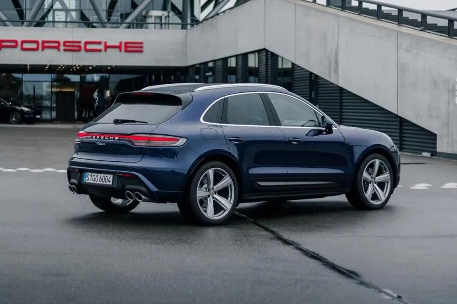 porsche macan parked in front of porsche building