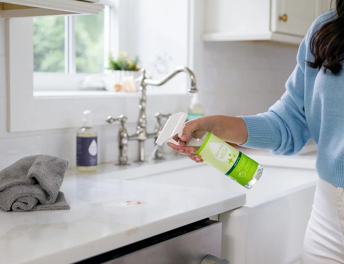 a woman cleaning a kitchen