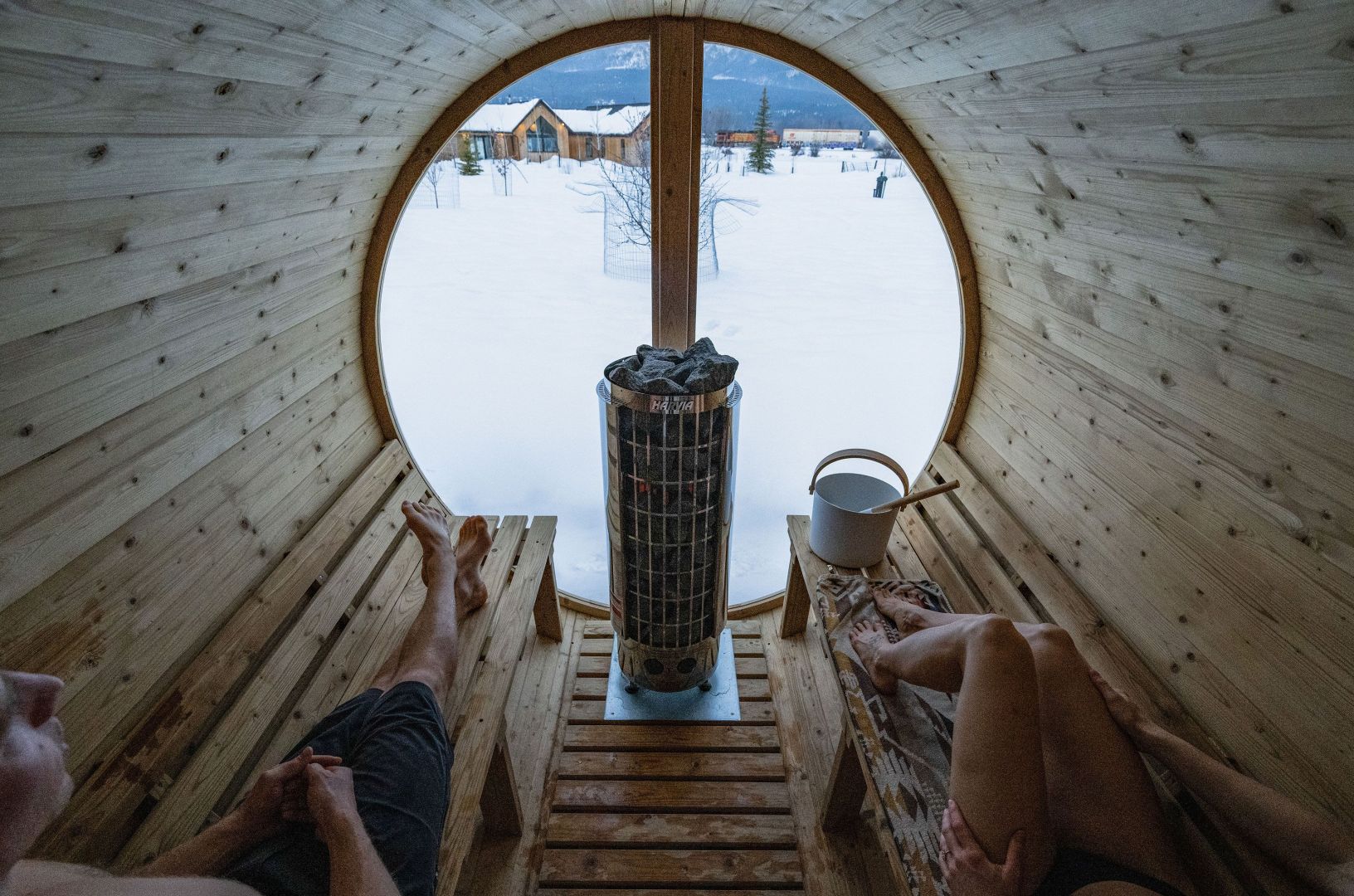 man and woman sitting in sauna
