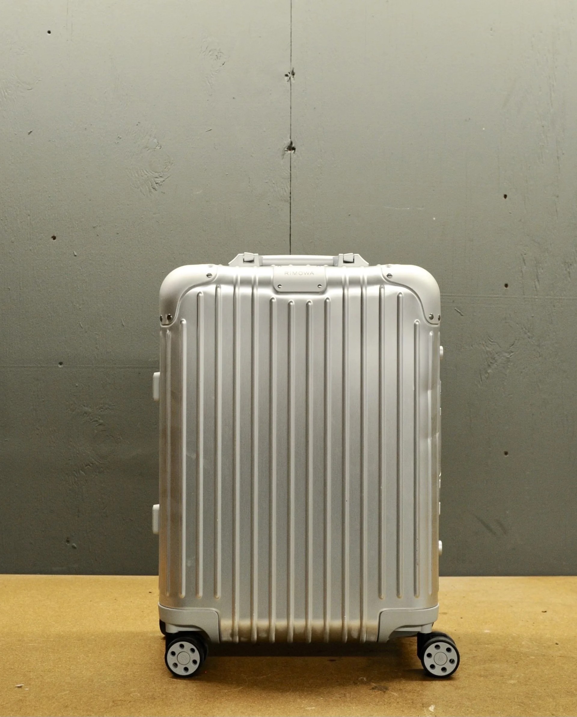 rimowa suitcase on a table