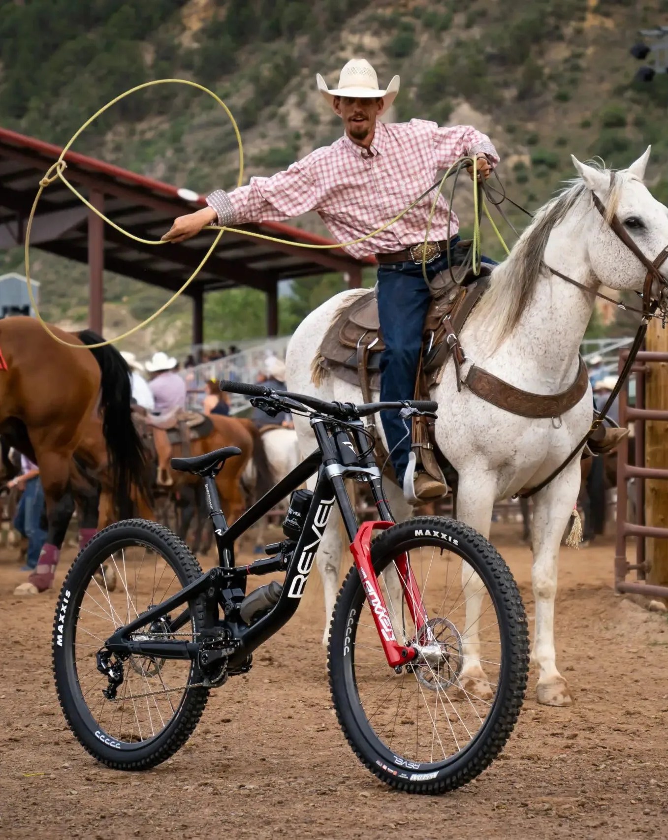 man riding horse in corral aiming lasso at revel bikes rodeo 3d printed carbon fiber downhill bike