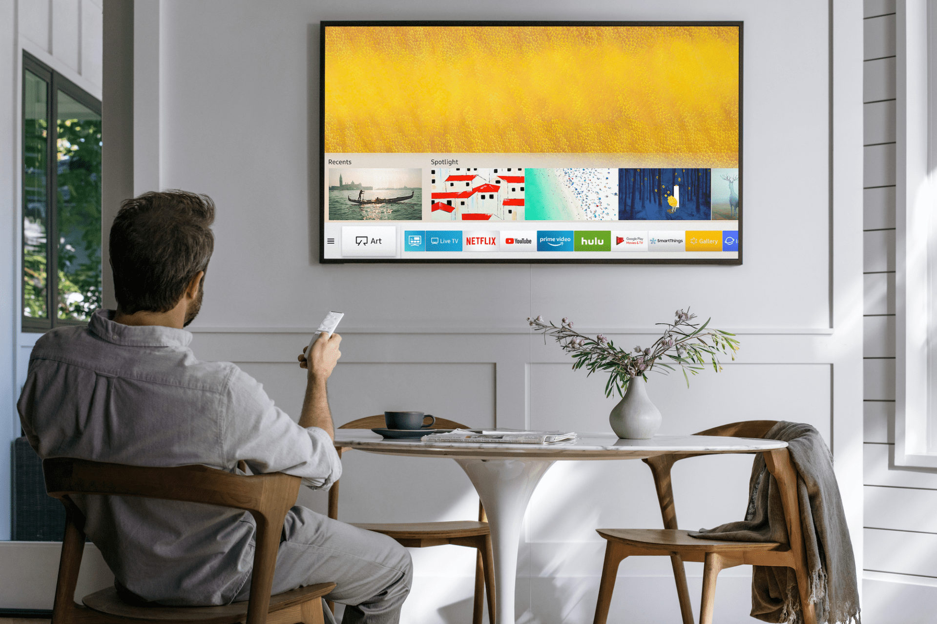 samsung the frame tv in room with man and modern breakfast table
