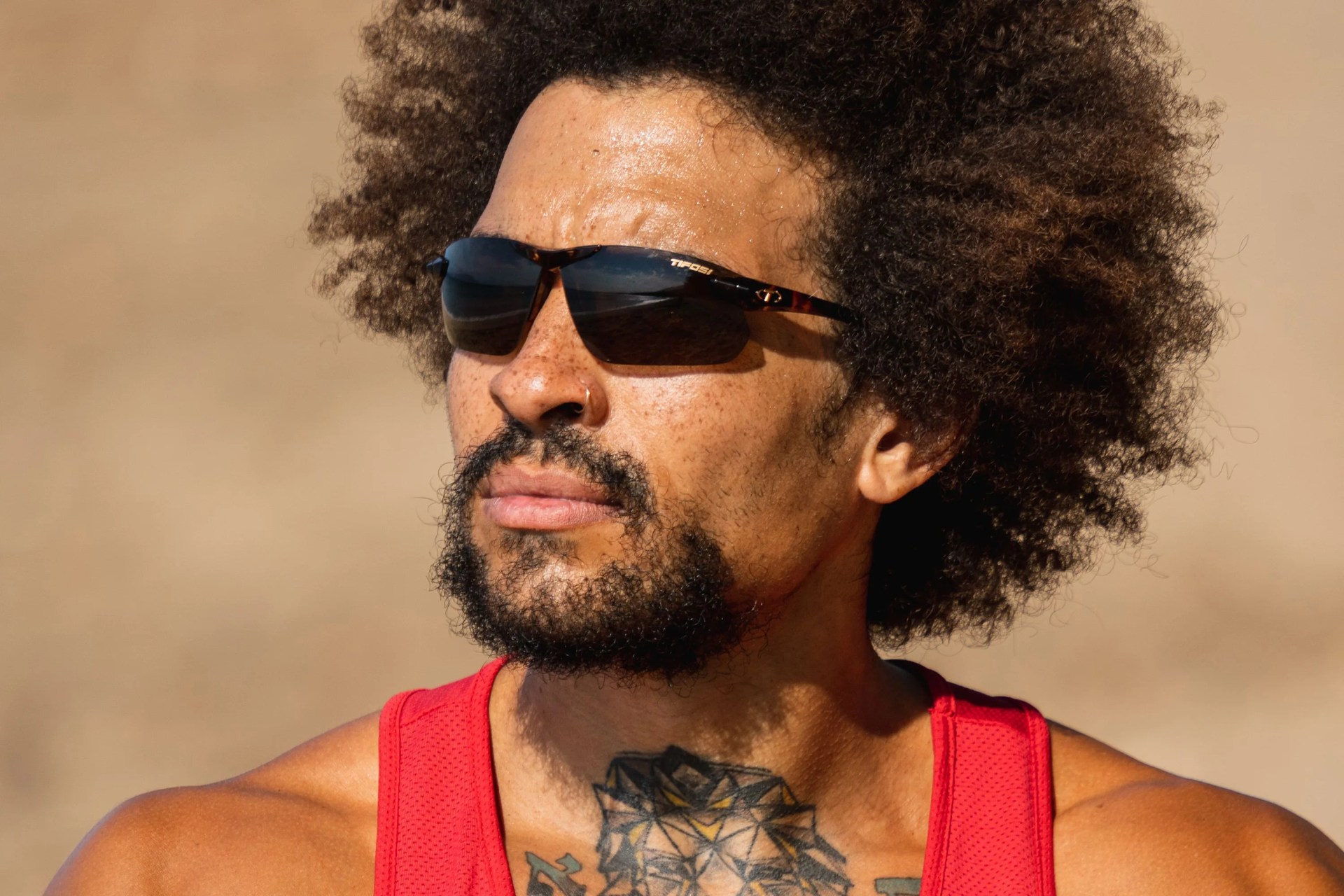 a man wearing tifosi sunglasses