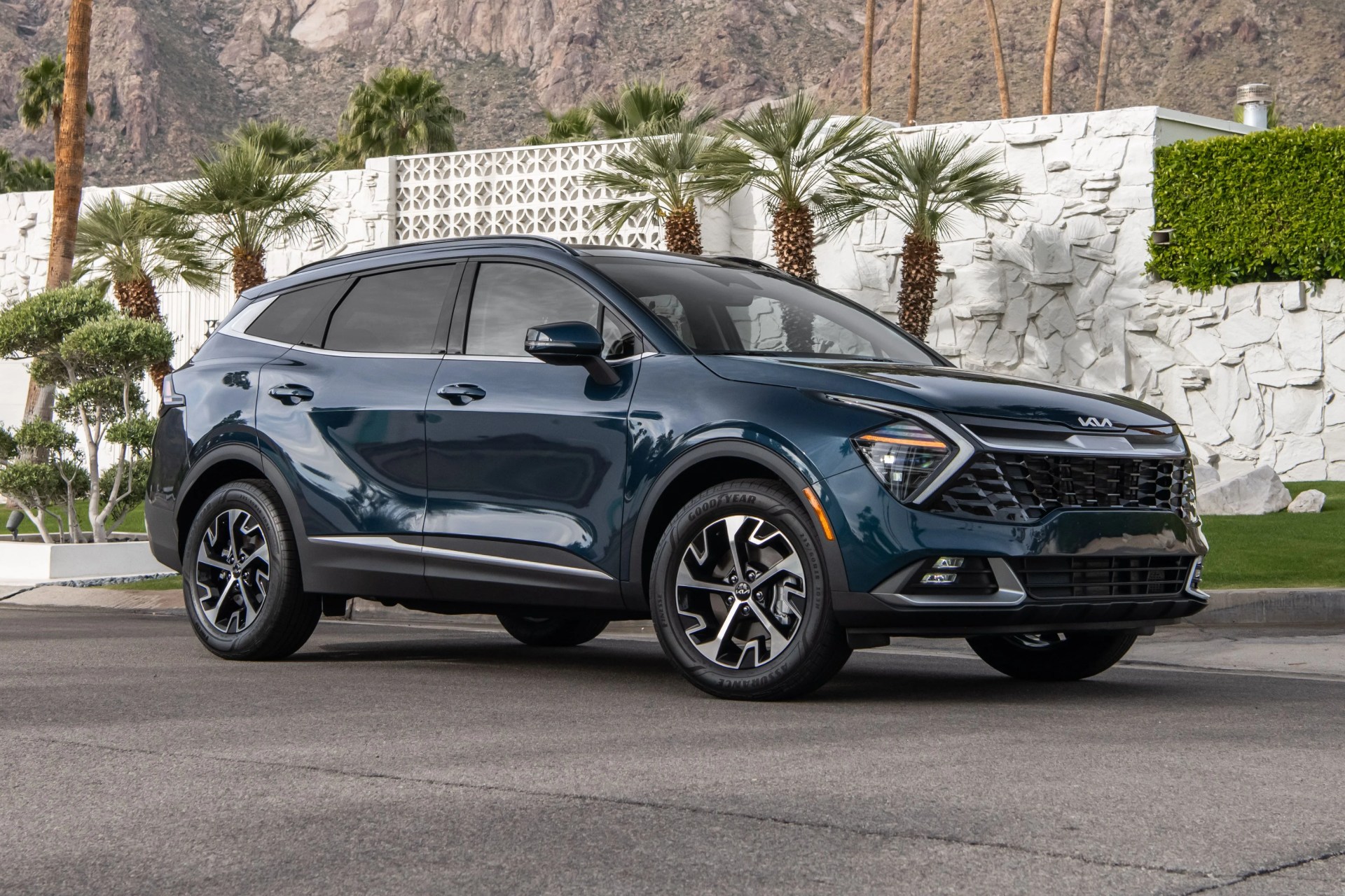kia sportage hybrid parked next to a palm springs house