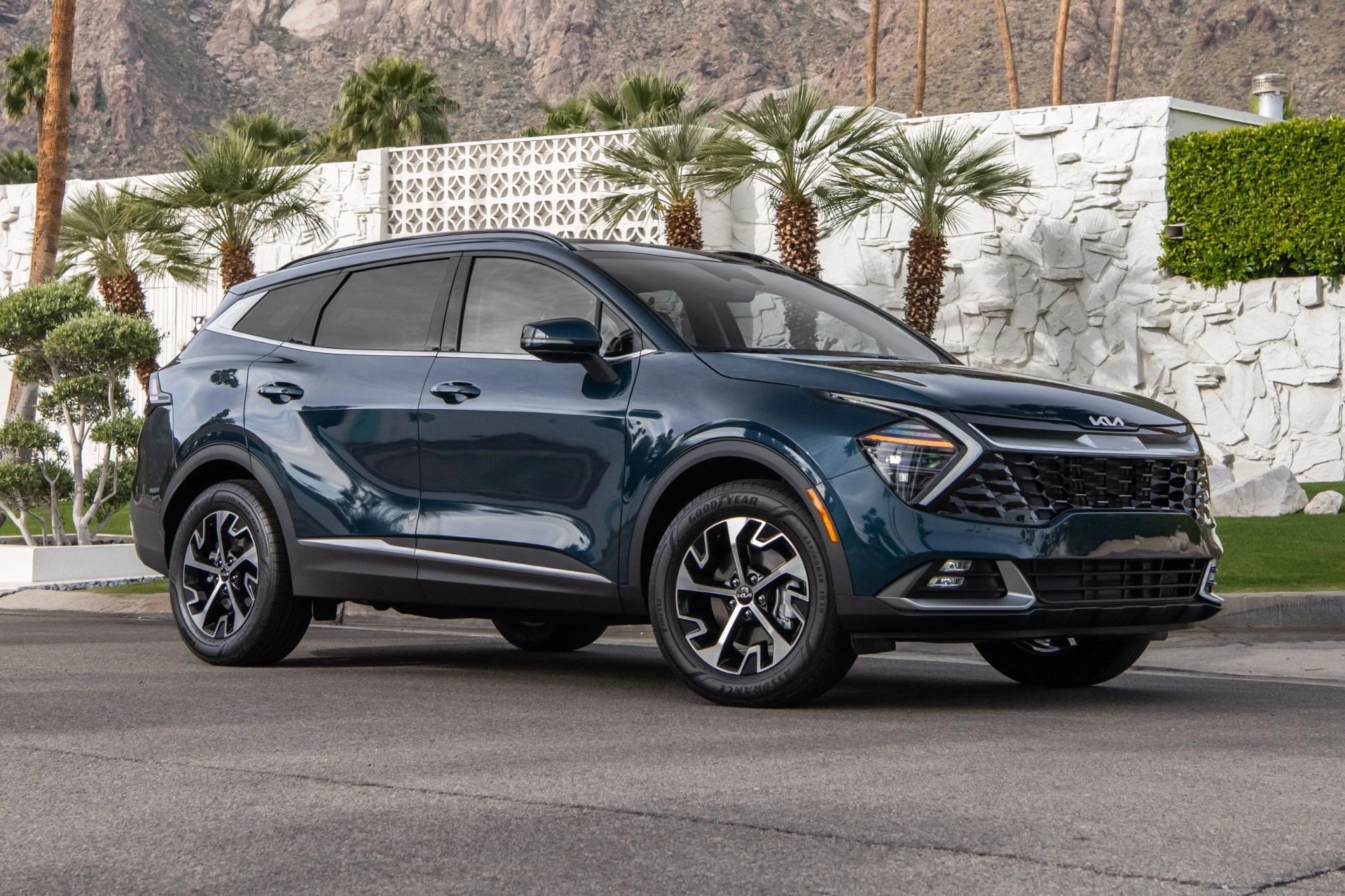 kia sportage hybrid parked next to a palm springs house