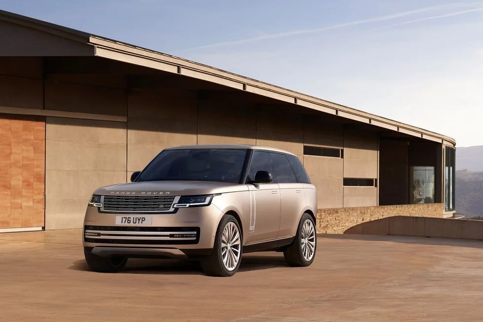 new range rover parked in front of modern house