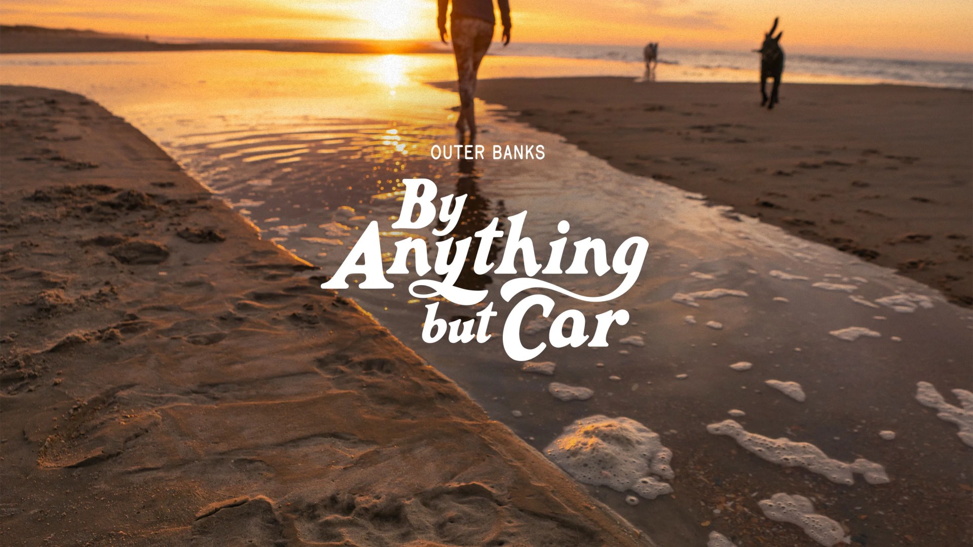 By Anything But Car person walking along the beach at Outerbanks