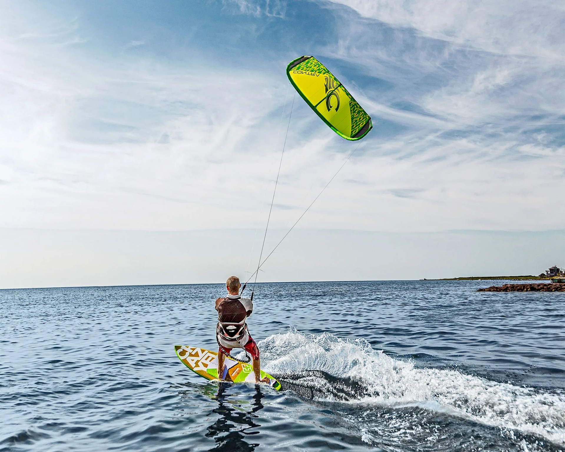 man kiteboarding in ocean