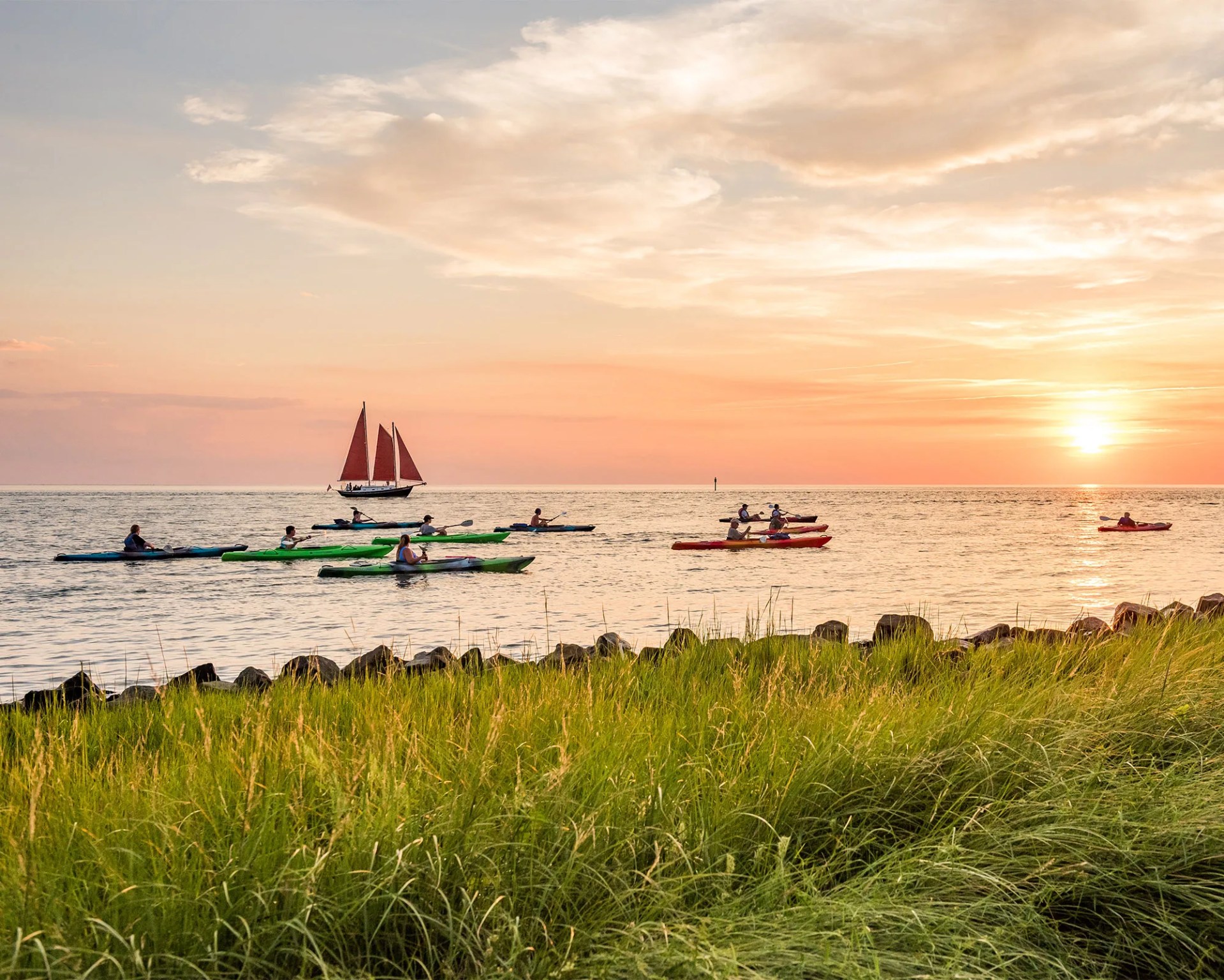 kayakers paddling during sunset