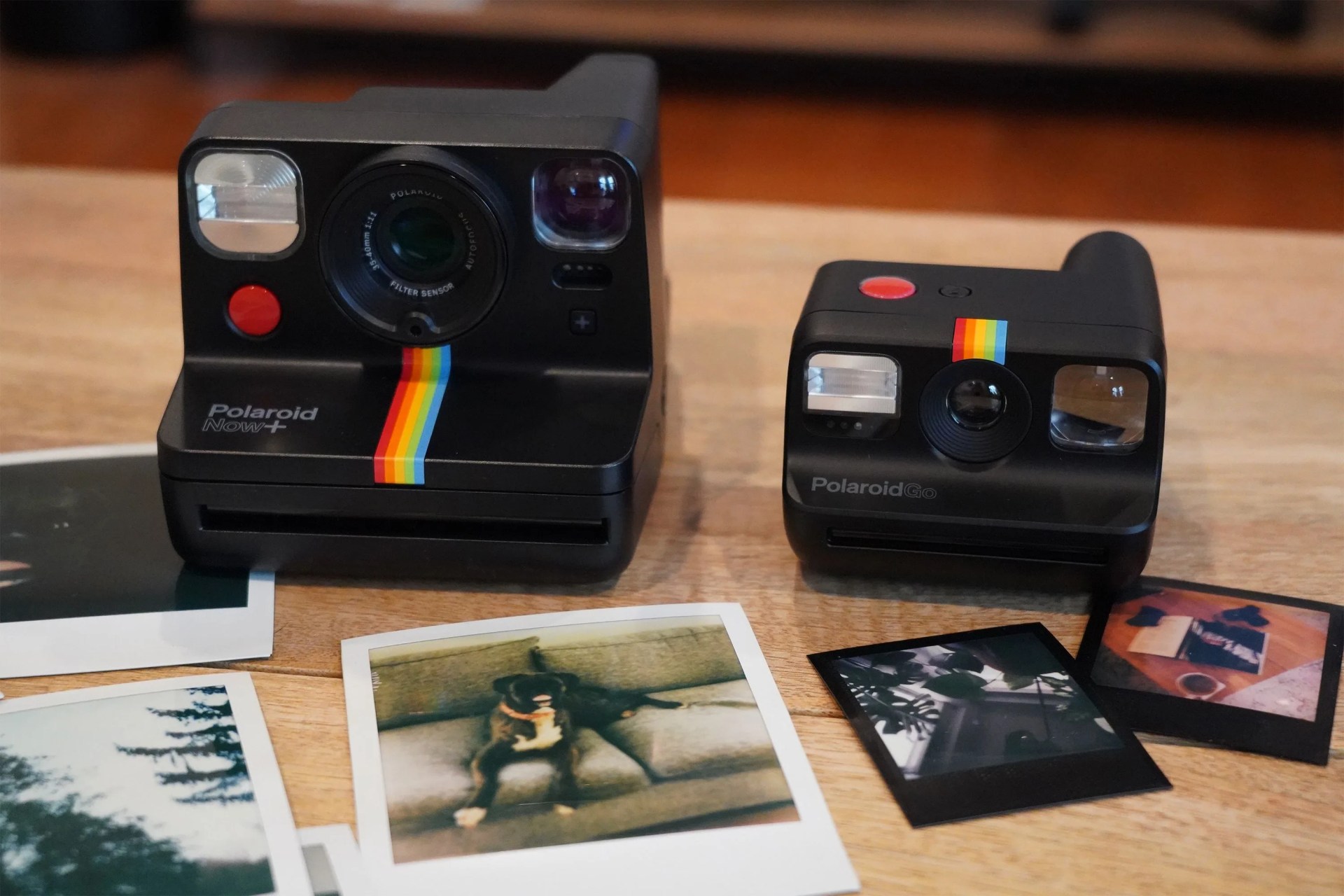 polaroid camera with polaroid photos on a table