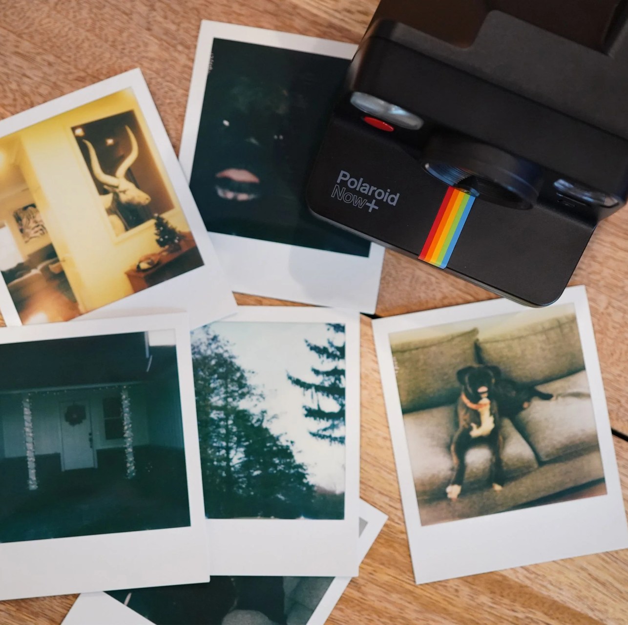 polaroid camera with polaroid photos on a table