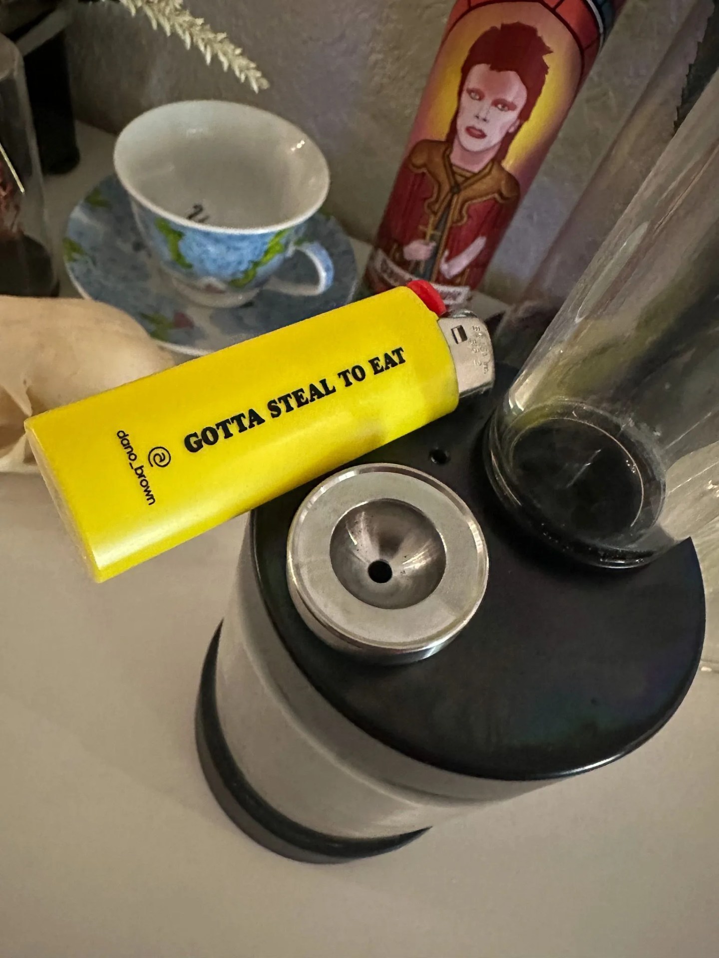 the top of a capsule water pipe with a lighter on it