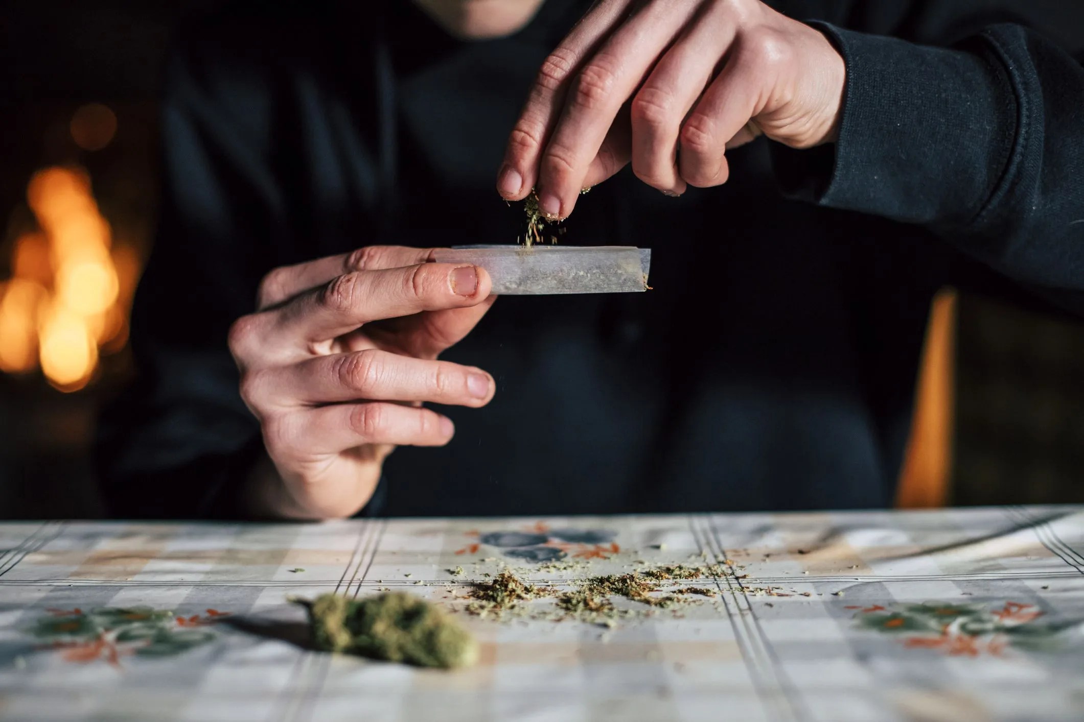 close up of a man's hands preparing marihuana joint