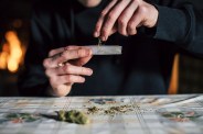 close up of a man's hands preparing marihuana joint