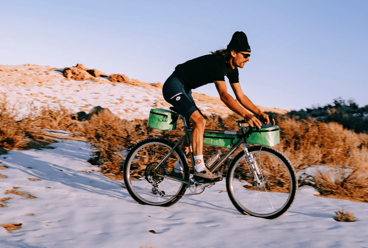 a man riding a bike through the snow