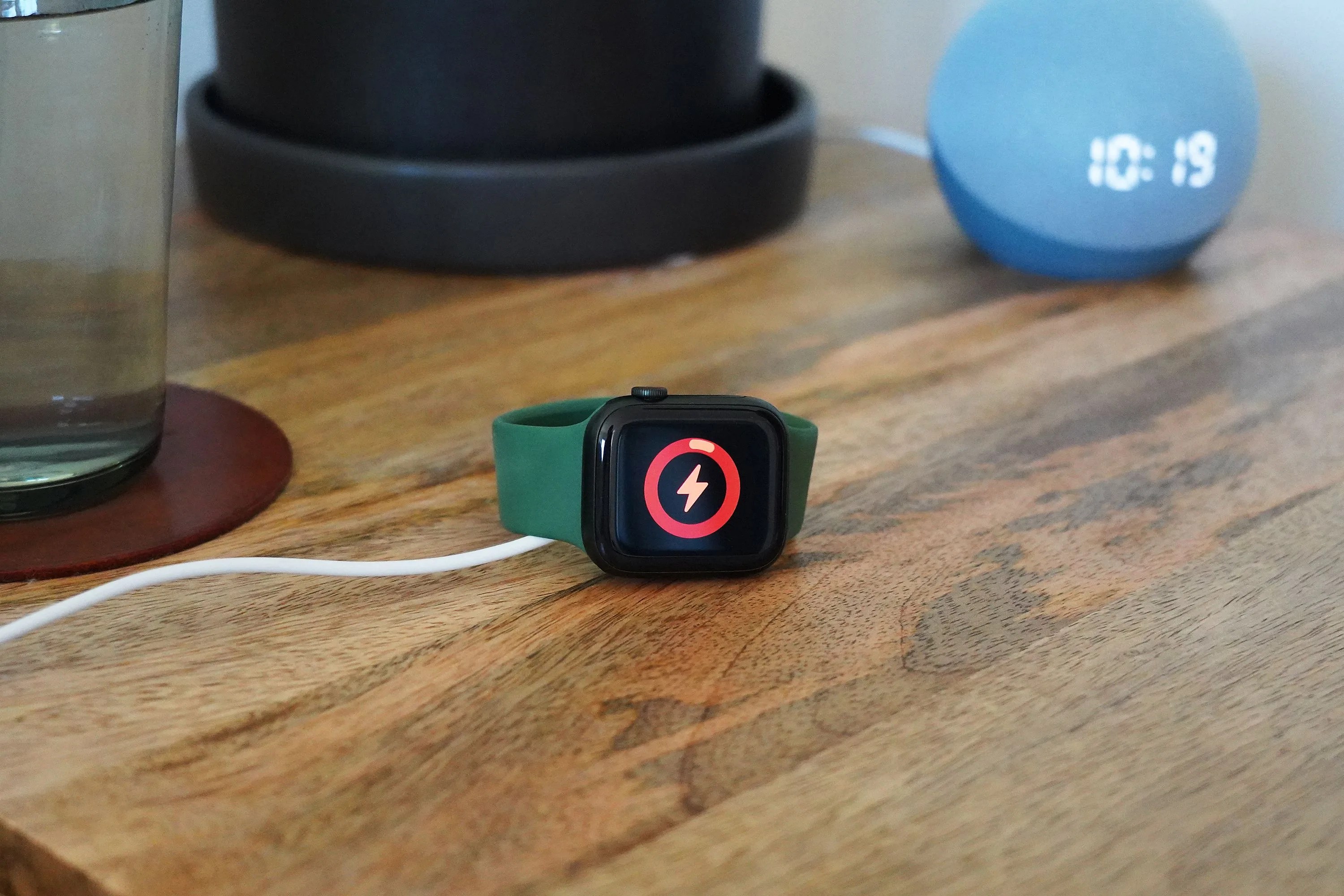 apple watch charging on a bedside table