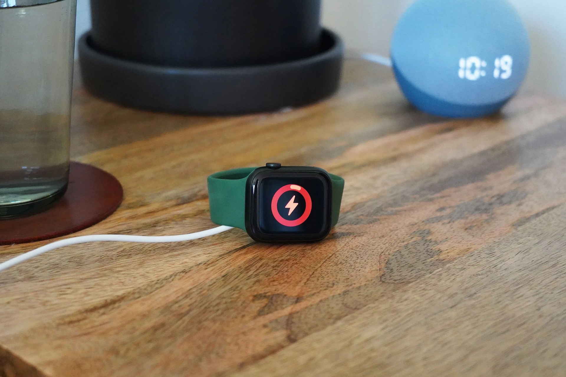 apple watch charging on a bedside table