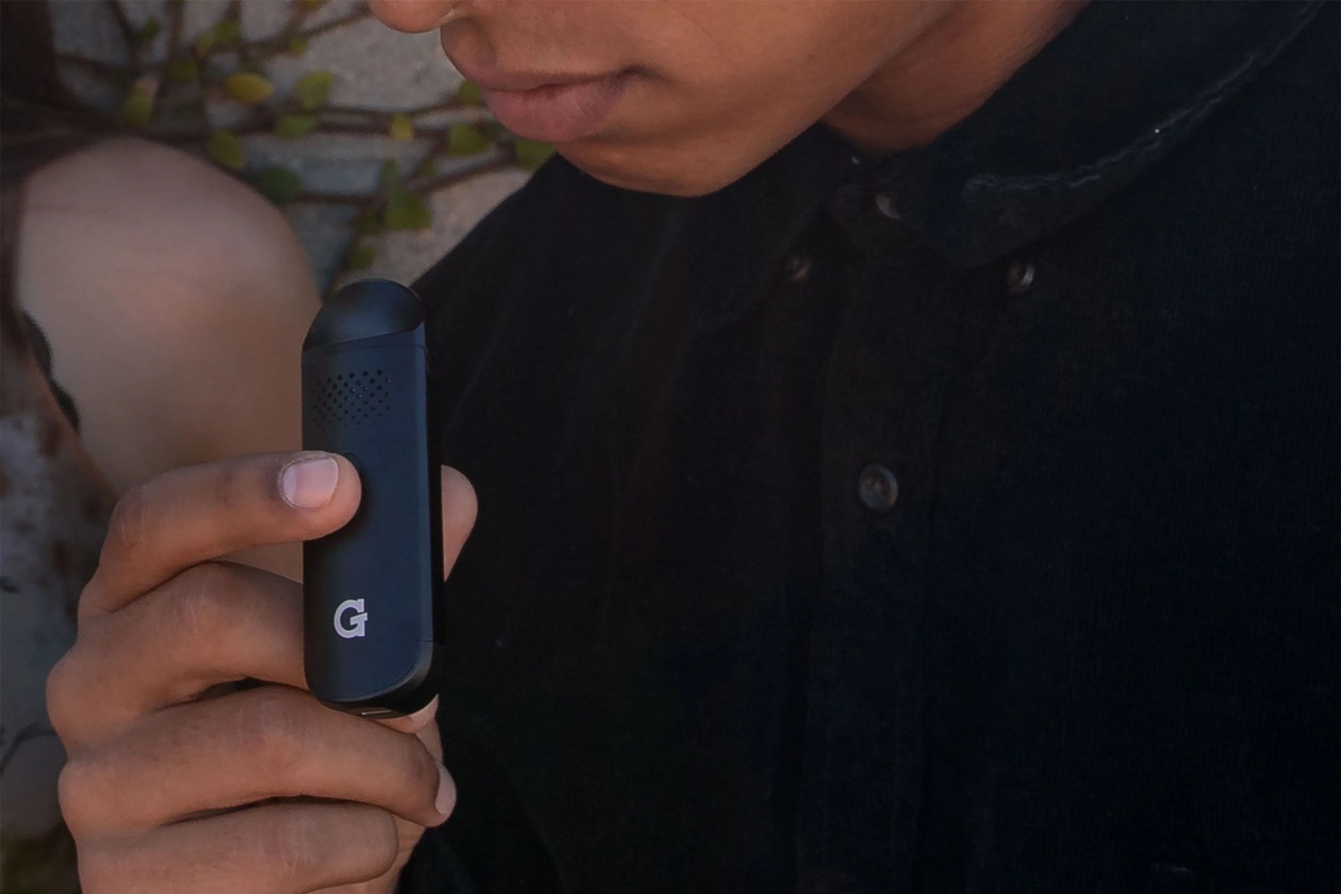 man smoking using g pen dash vaporizer