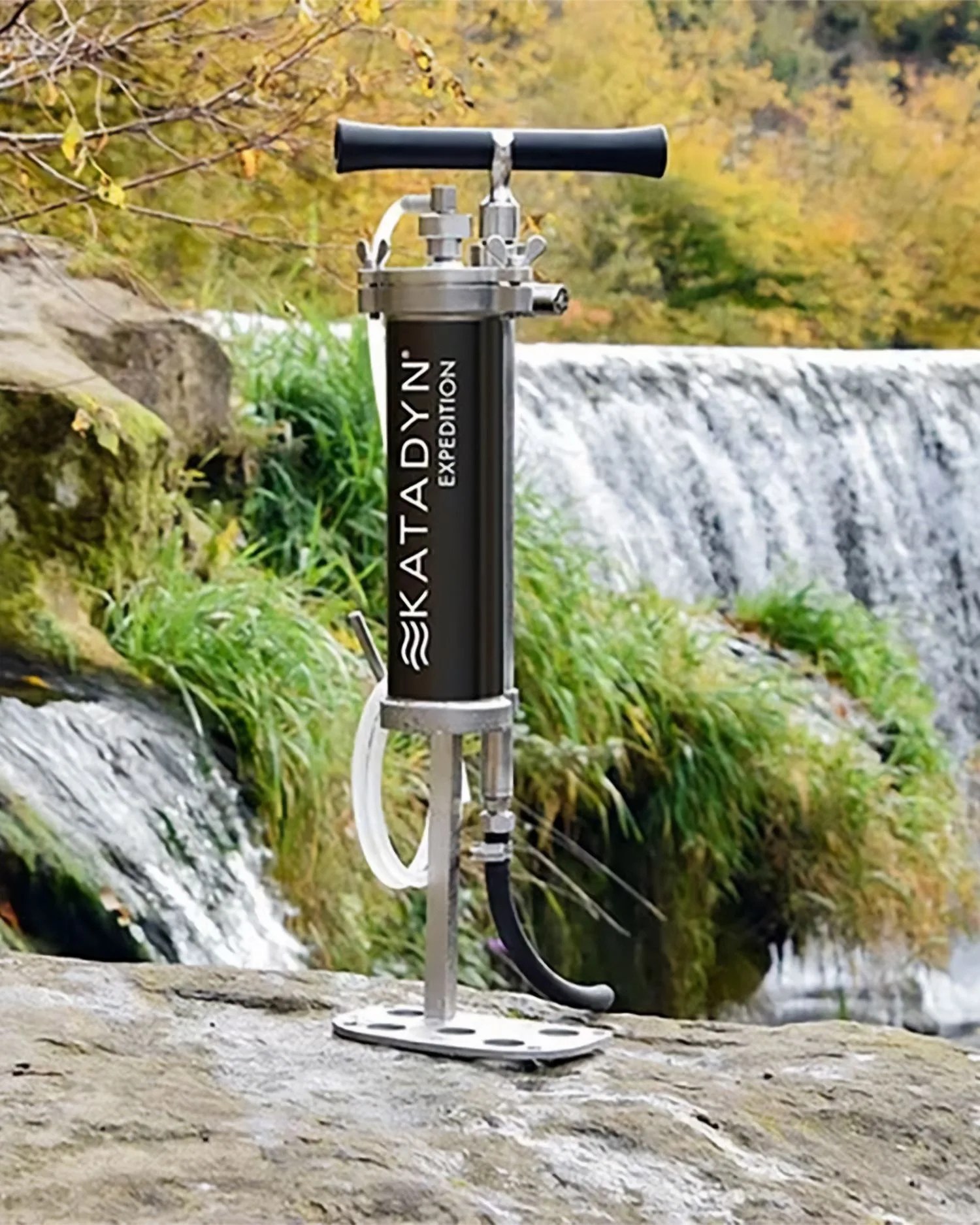 a water filter on a rock by a waterfall