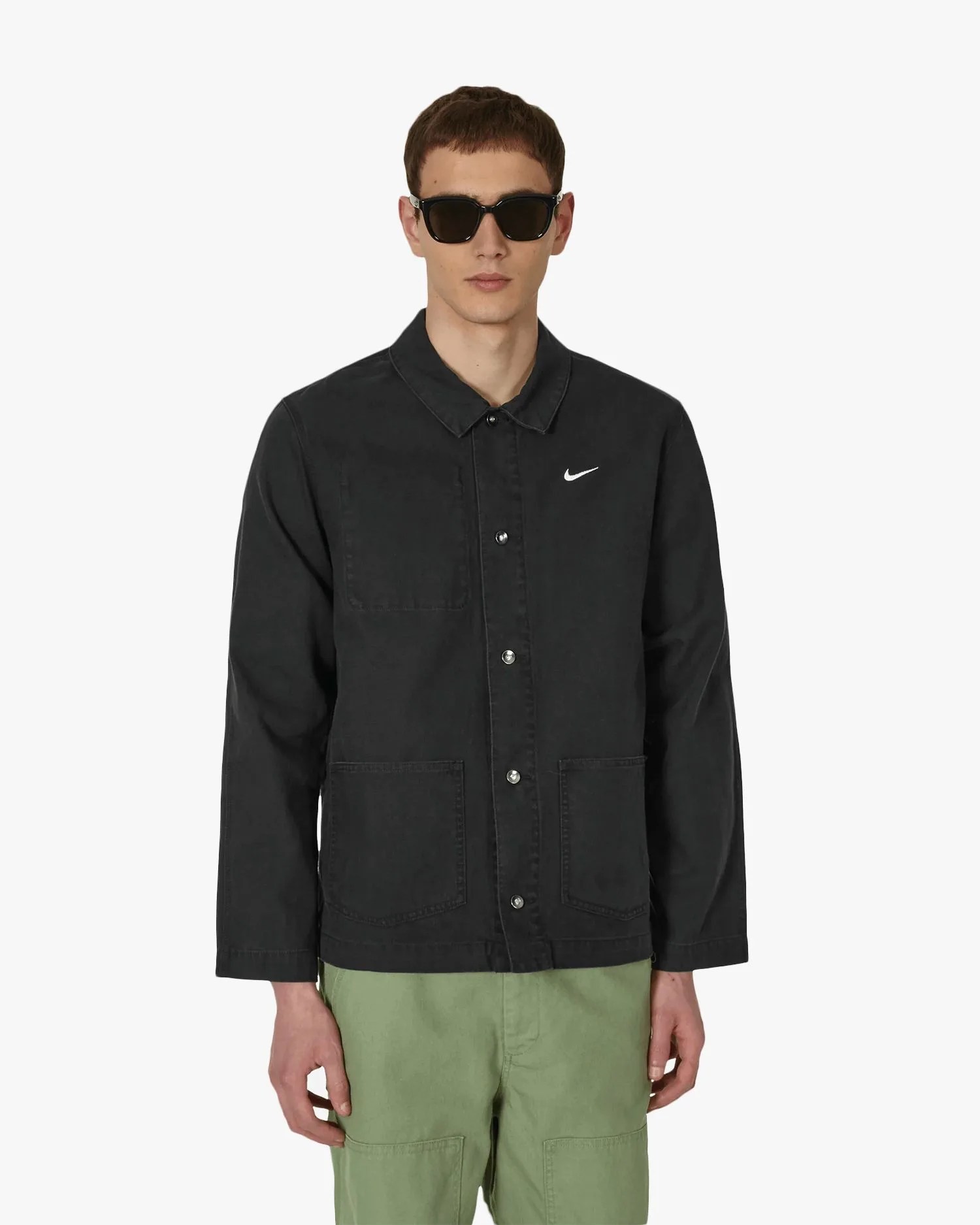 a man wearing a nike chore jacket